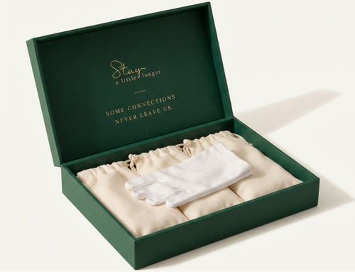 Stay design preview: open emerald keepsake box with gold lettering, cream pouches, and white gloves.